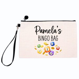 A personalised linen-style bingo pouch with the customisable name “Pamela’s Bingo Bag” printed above colourful bingo balls and gold coins. The pouch features a black zip closure, detachable wrist strap, and durable fabric design. Ideal as a custom dabber or pen case, unique bingo gift for her, mum, nana or friend, handmade by Drifting Ducks. Perfect birthday or Mother’s Day gift idea for bingo lovers.