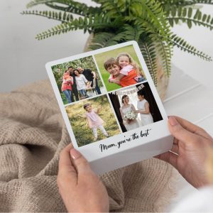 Personalized metal photo stand for family, featuring a custom 4-photo collage and text. Perfect gift for Mum, displaying cherished memories with children and loved ones. The stand is shown held by hands, with a potted plant and a light-colored blanket in the background.